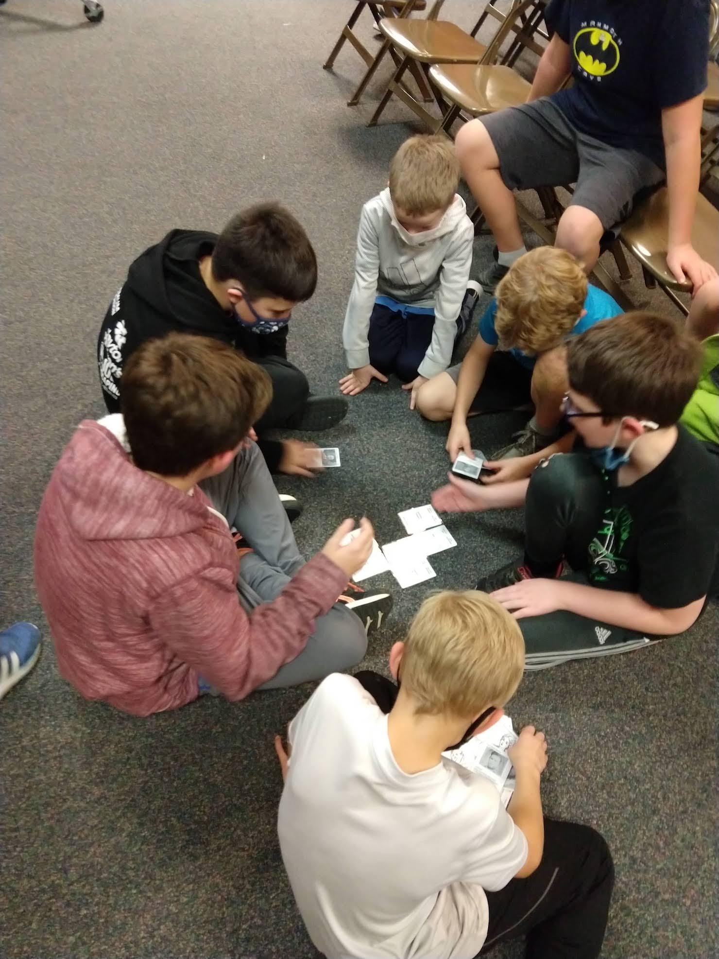 boys gather around to assemble a tree also