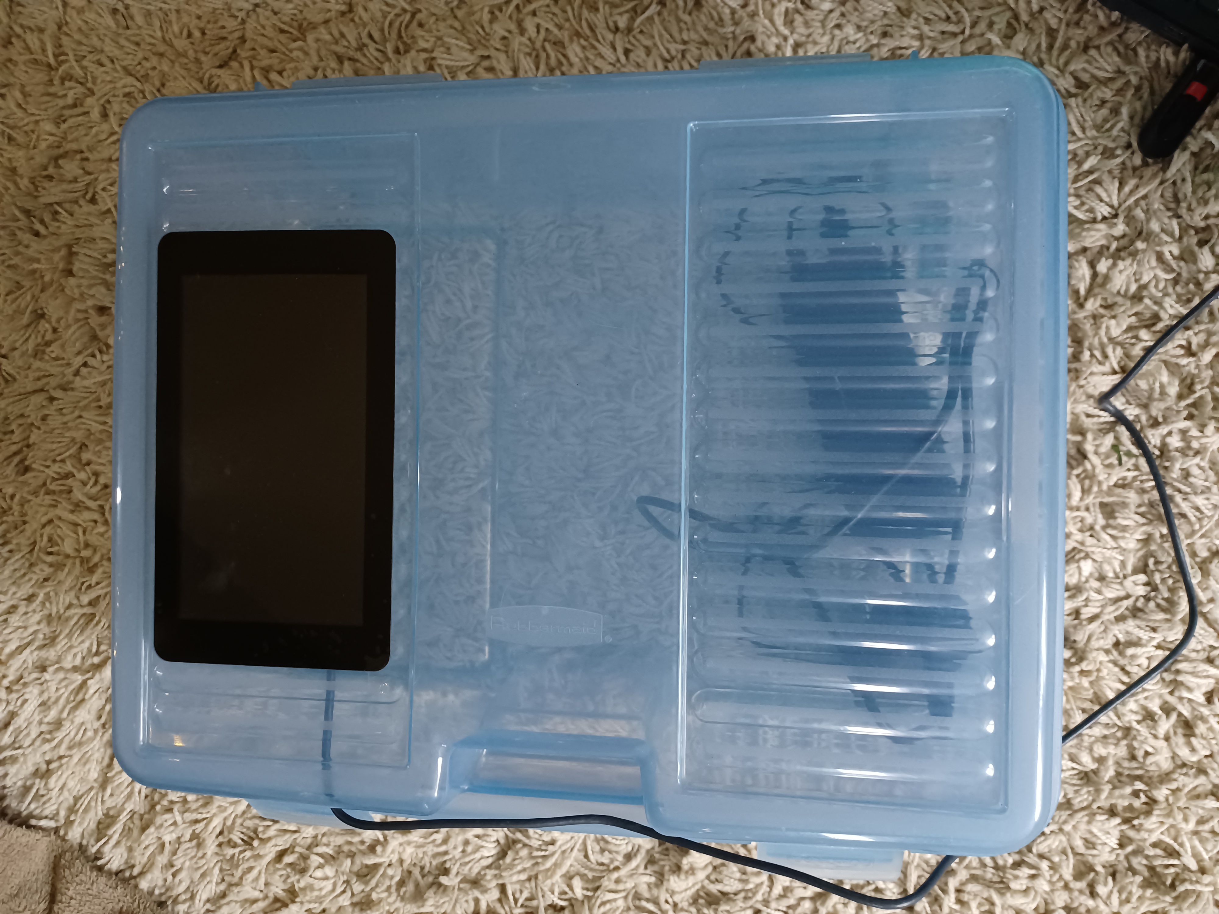 a touch screen mounted on a plastic bin