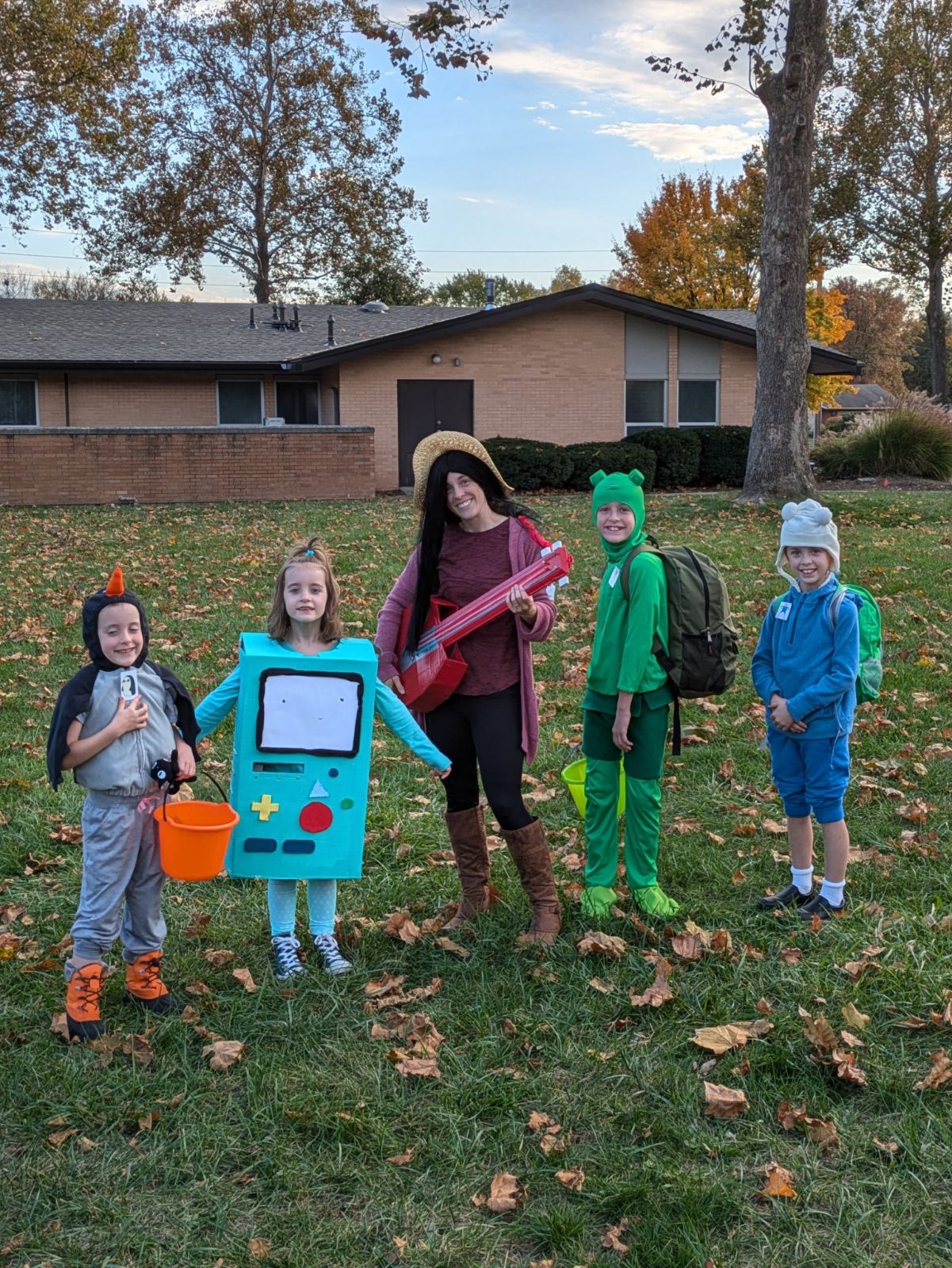 five family members dressed up as Gunther, Finn, Fern, Marcelline, and BMO