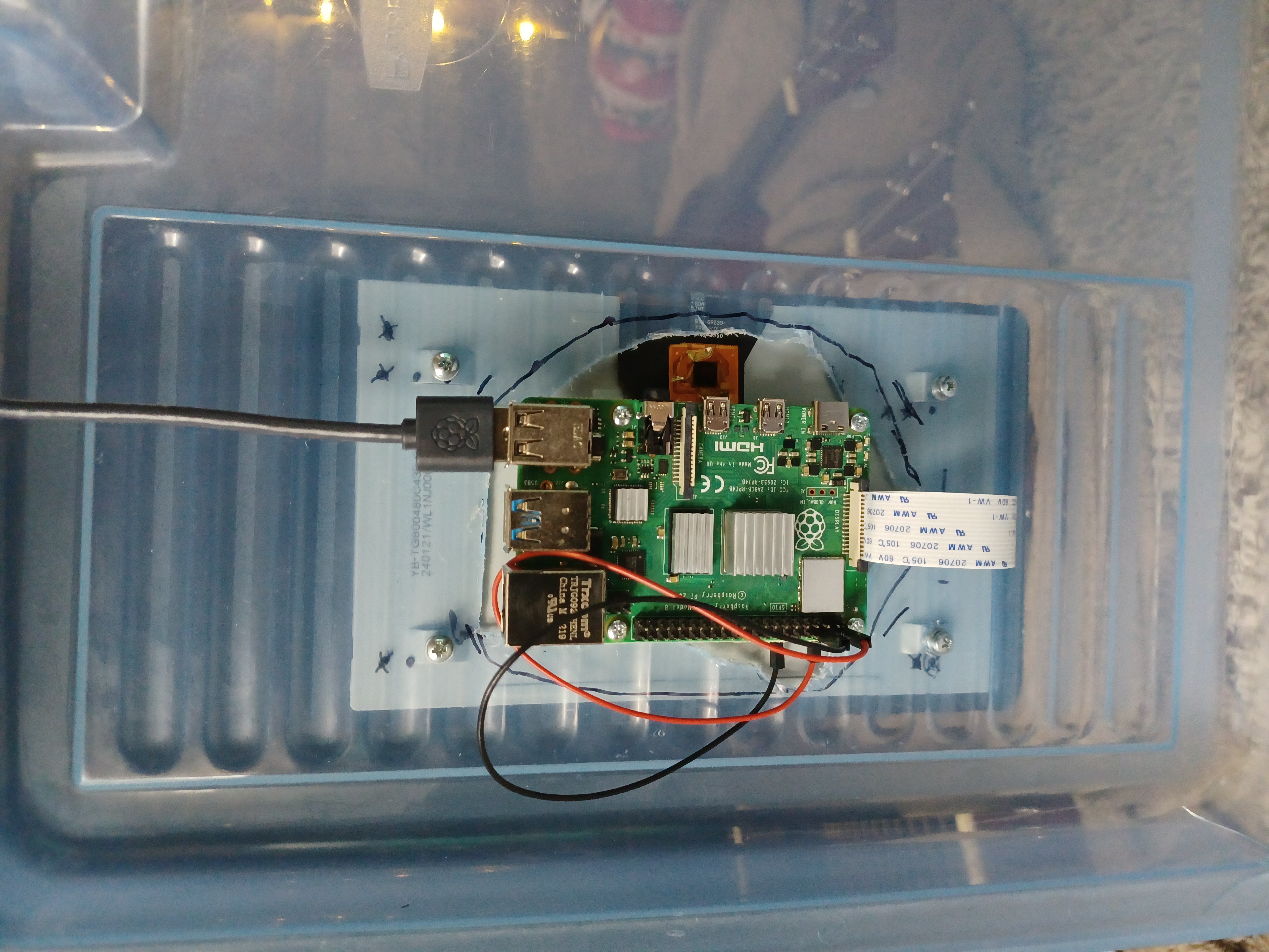 a raspberry pi mounted on a plastic bin