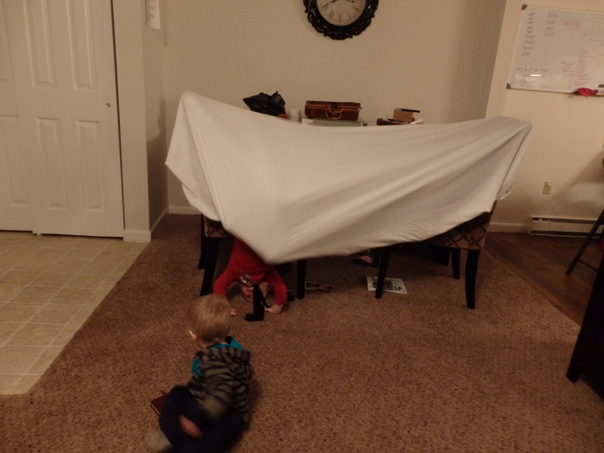a blanket fort with children coming in and out of it