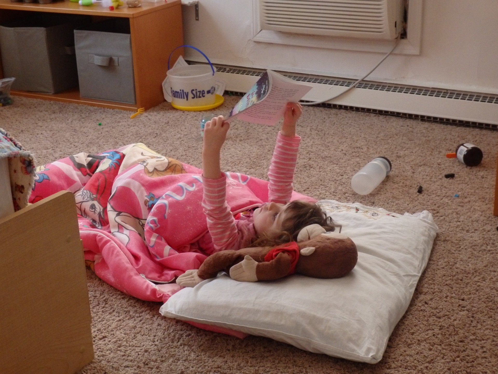 Princess Heidi reading a princess book in her princess sleeping bag with her princess tiara