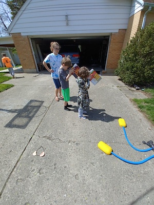 children looking through pinhole camera