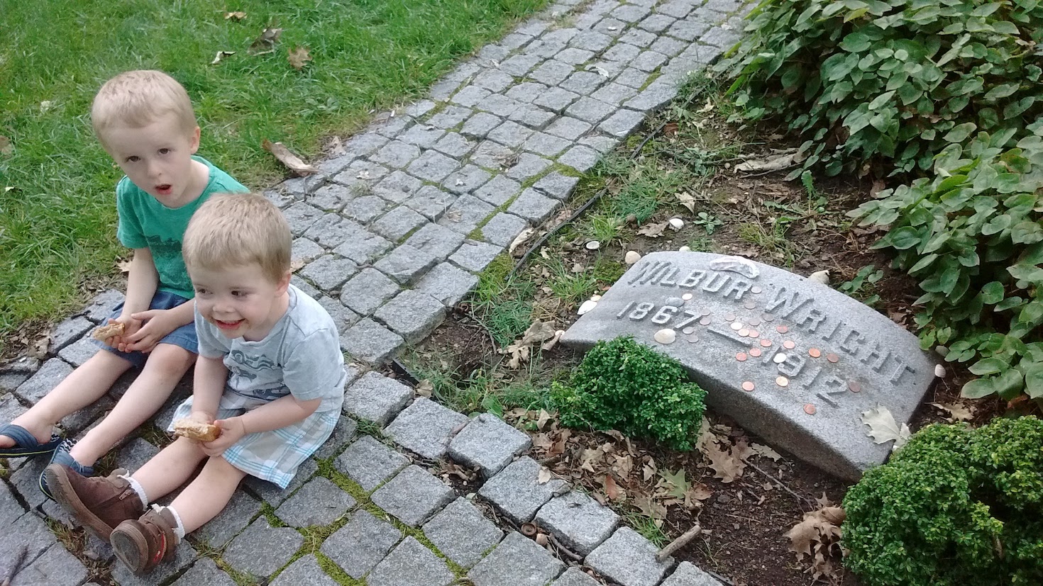 little boys sitting near wright bros grave