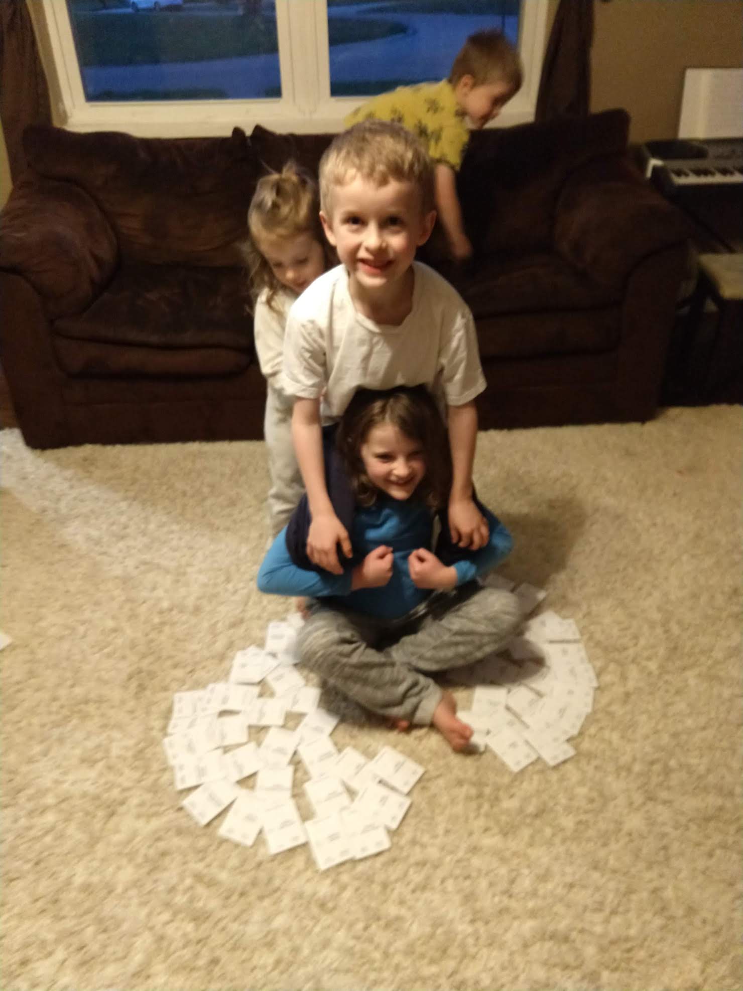 children sitting with cards arranged in a family tree shape