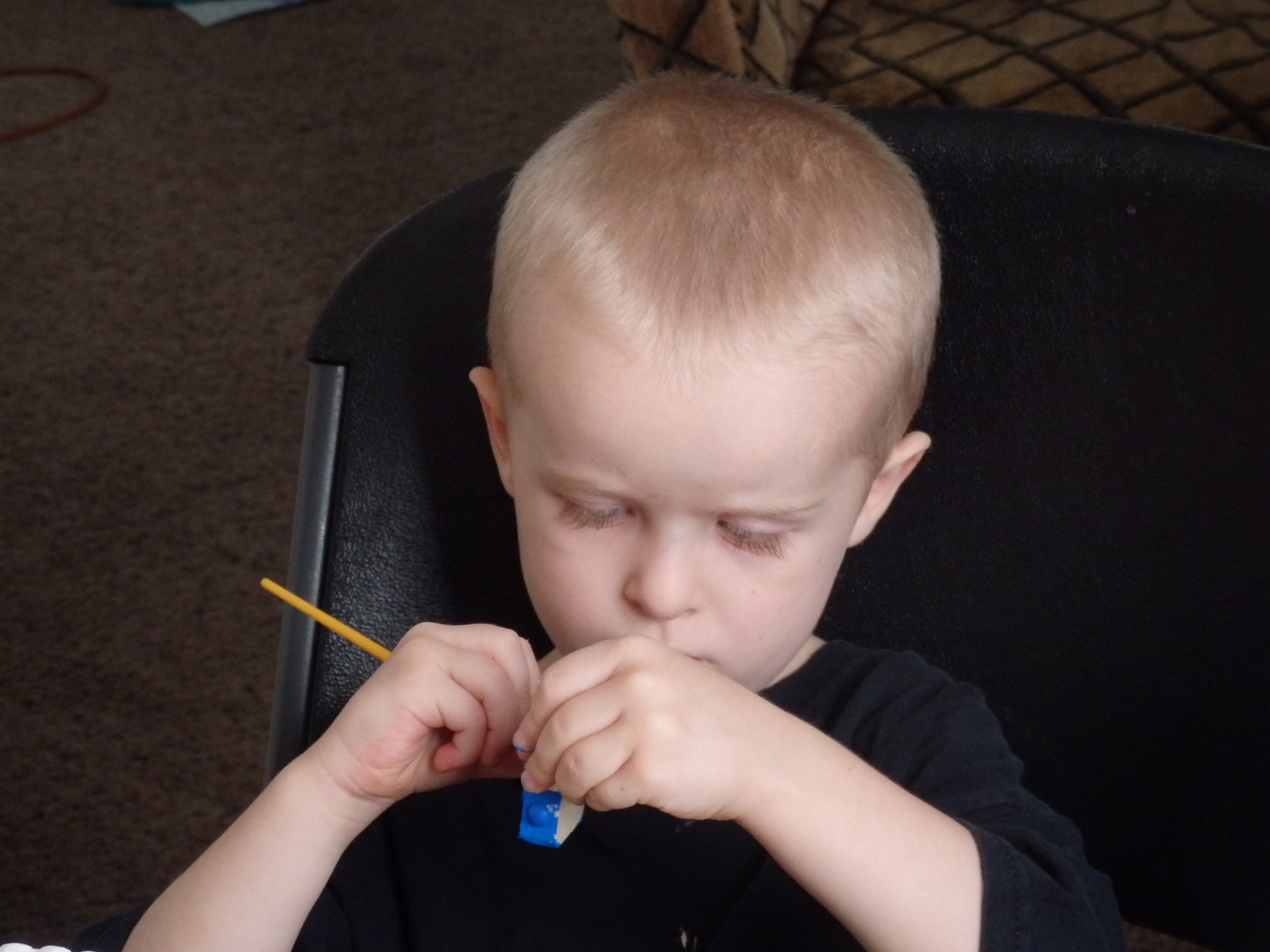 Peter focusing intently on painting a robot