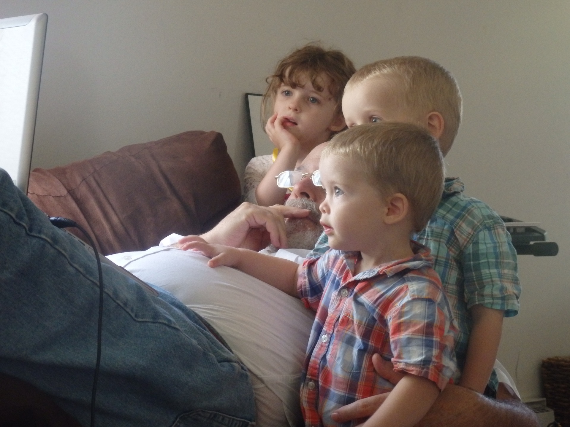 three children mesmerized by a computer