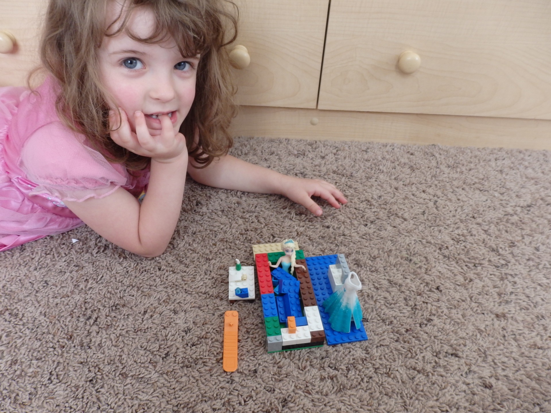 Elsa magic clip doll bathing in a lego bathtub