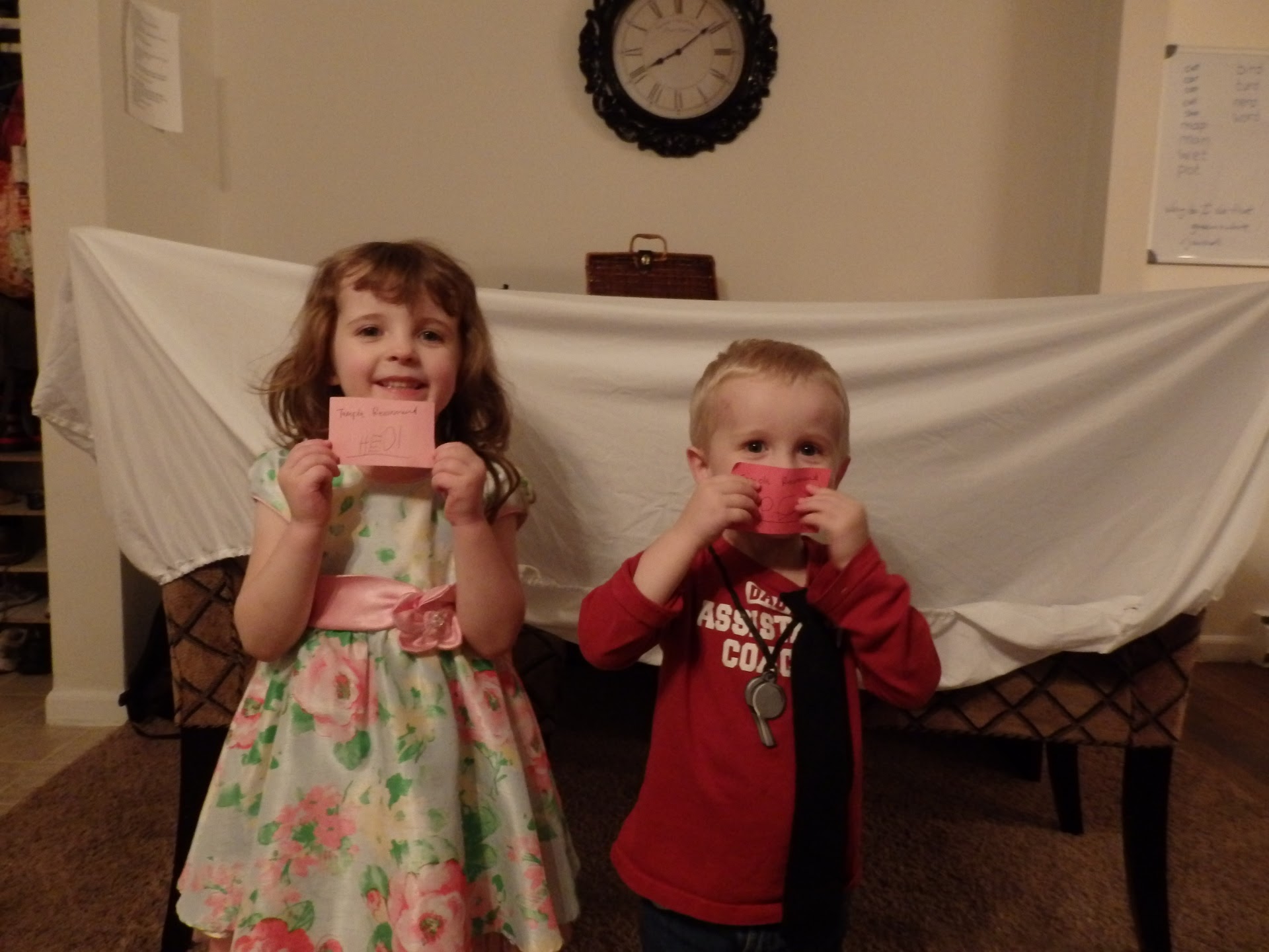 children holding up pieces of paper that look like temple recommends