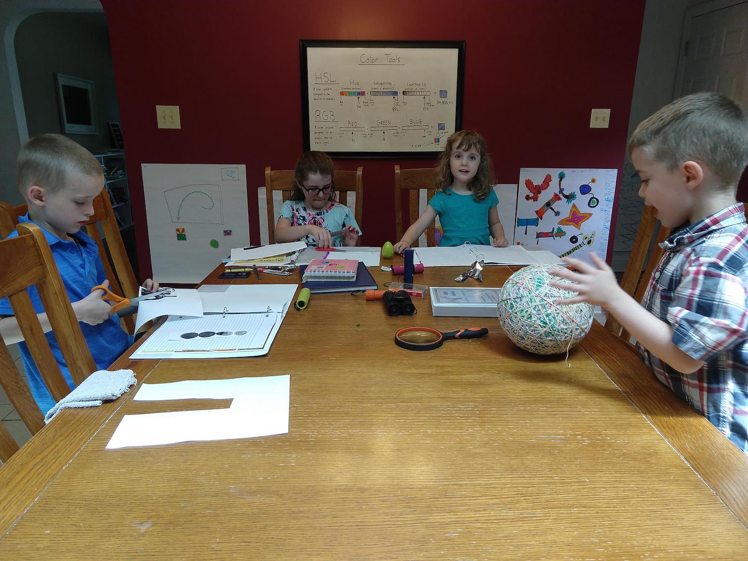 children working on family history mysteries at the kitchen table