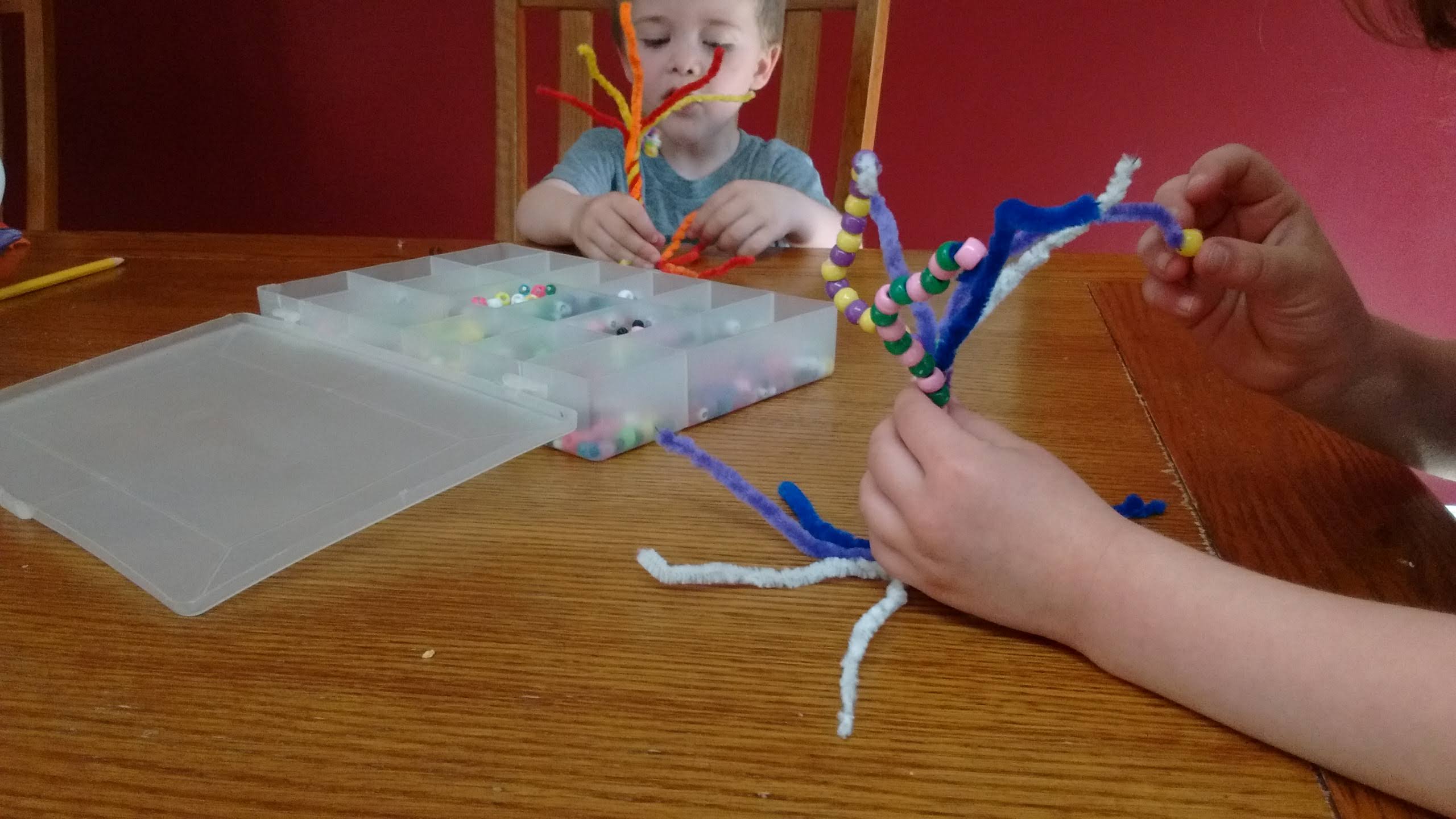 twist pipe cleaners together to form a tree with roots and branches, then thread pony beads on the branches