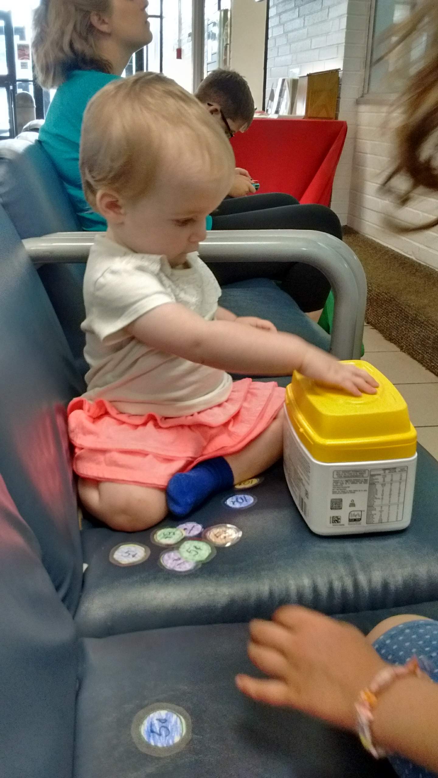 a baby playing with the coin box