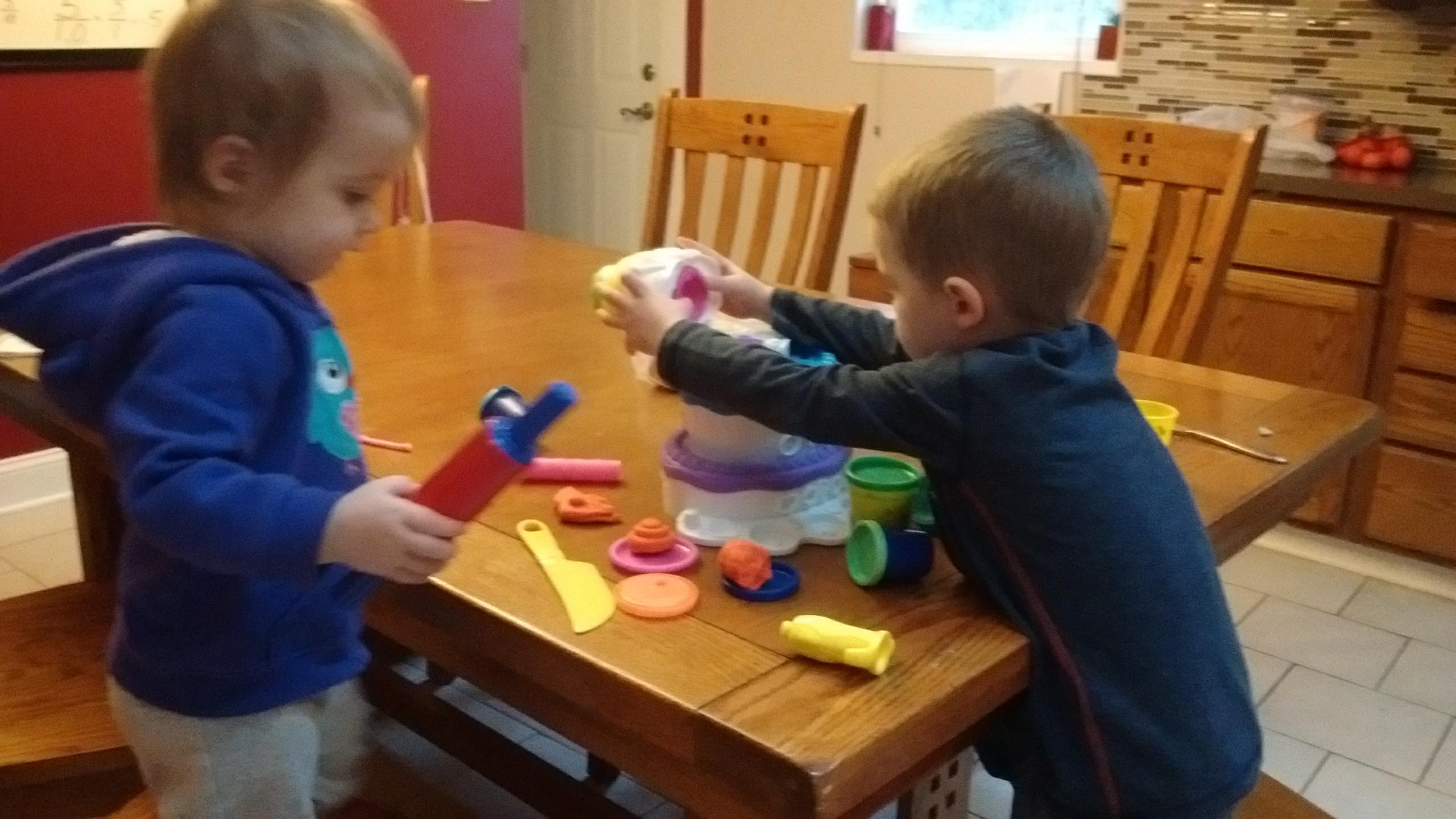 two children playing with playdoh