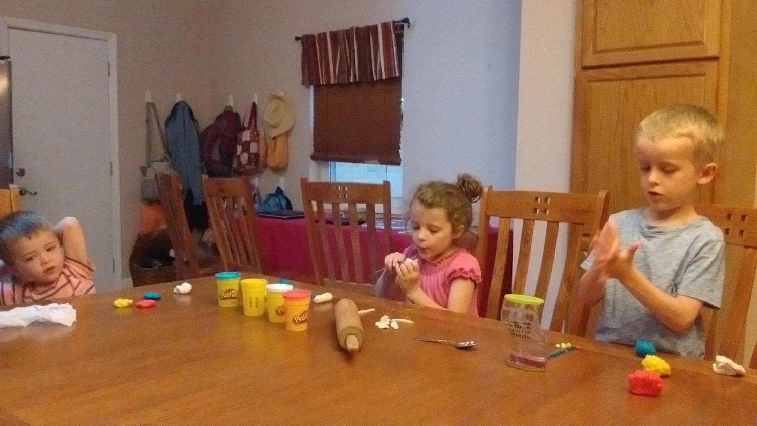 three children playing with playdoh