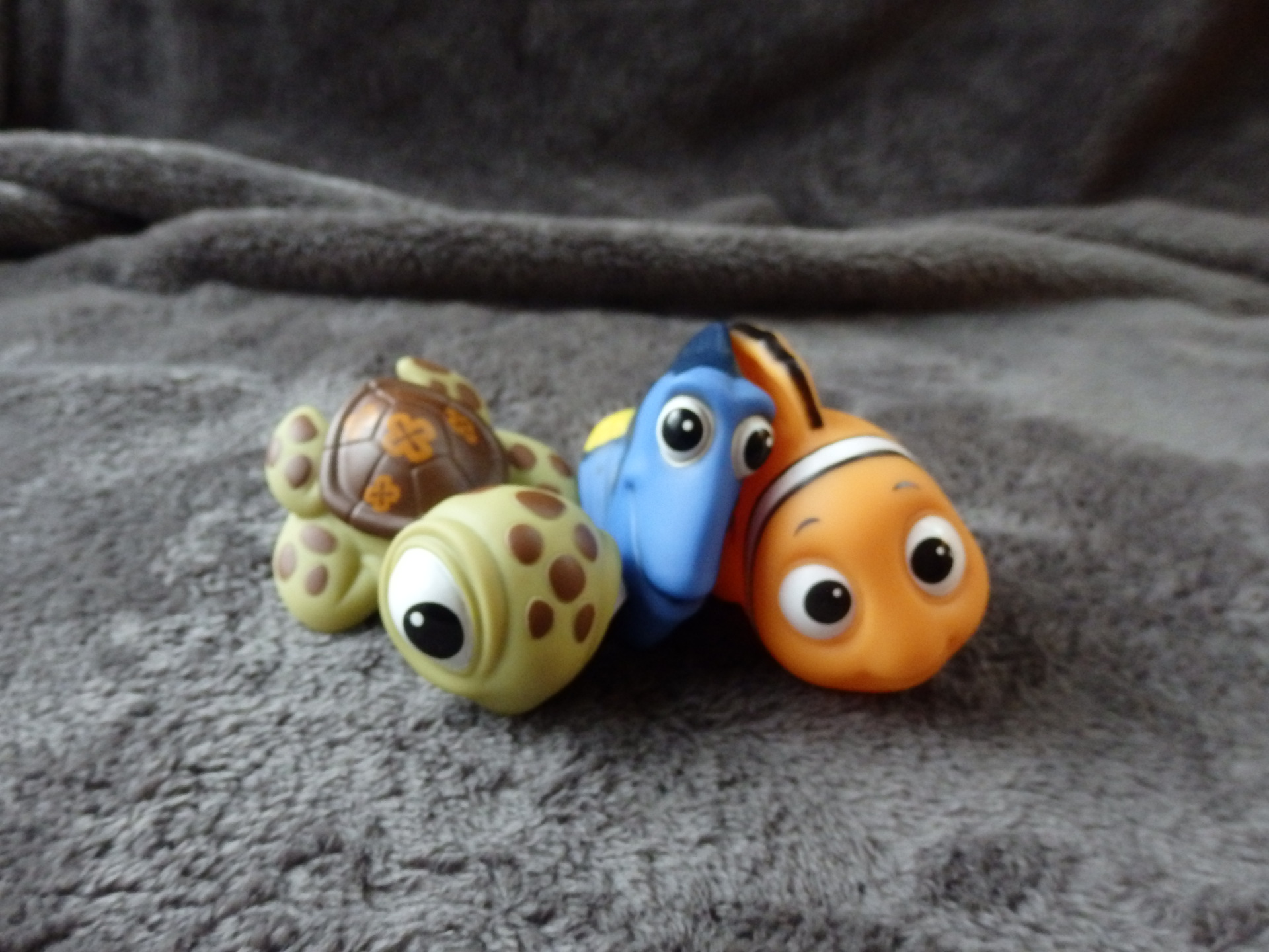 four squirt toys in the shape of Finding Nemo characters