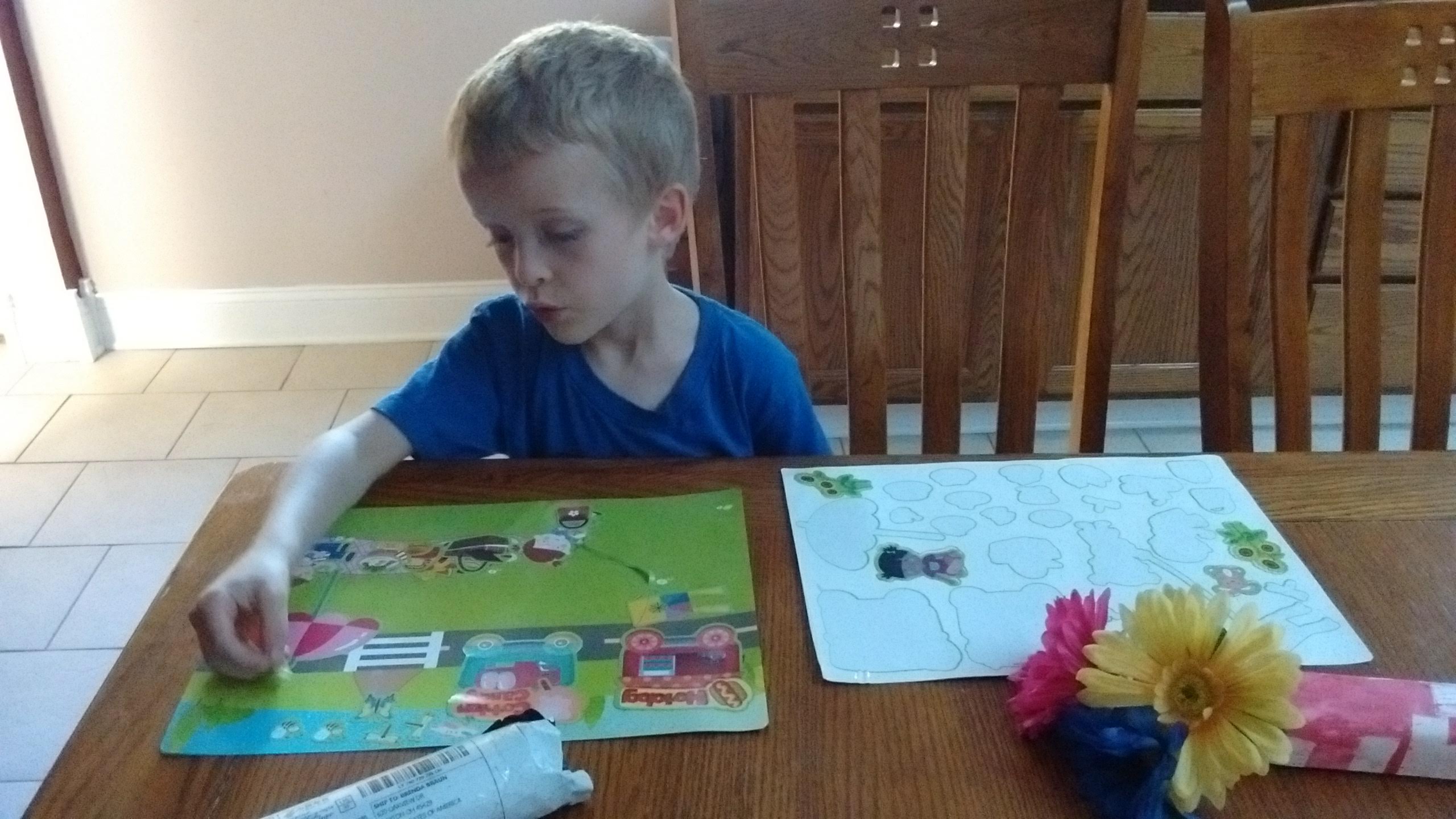 a boy playing with stickers