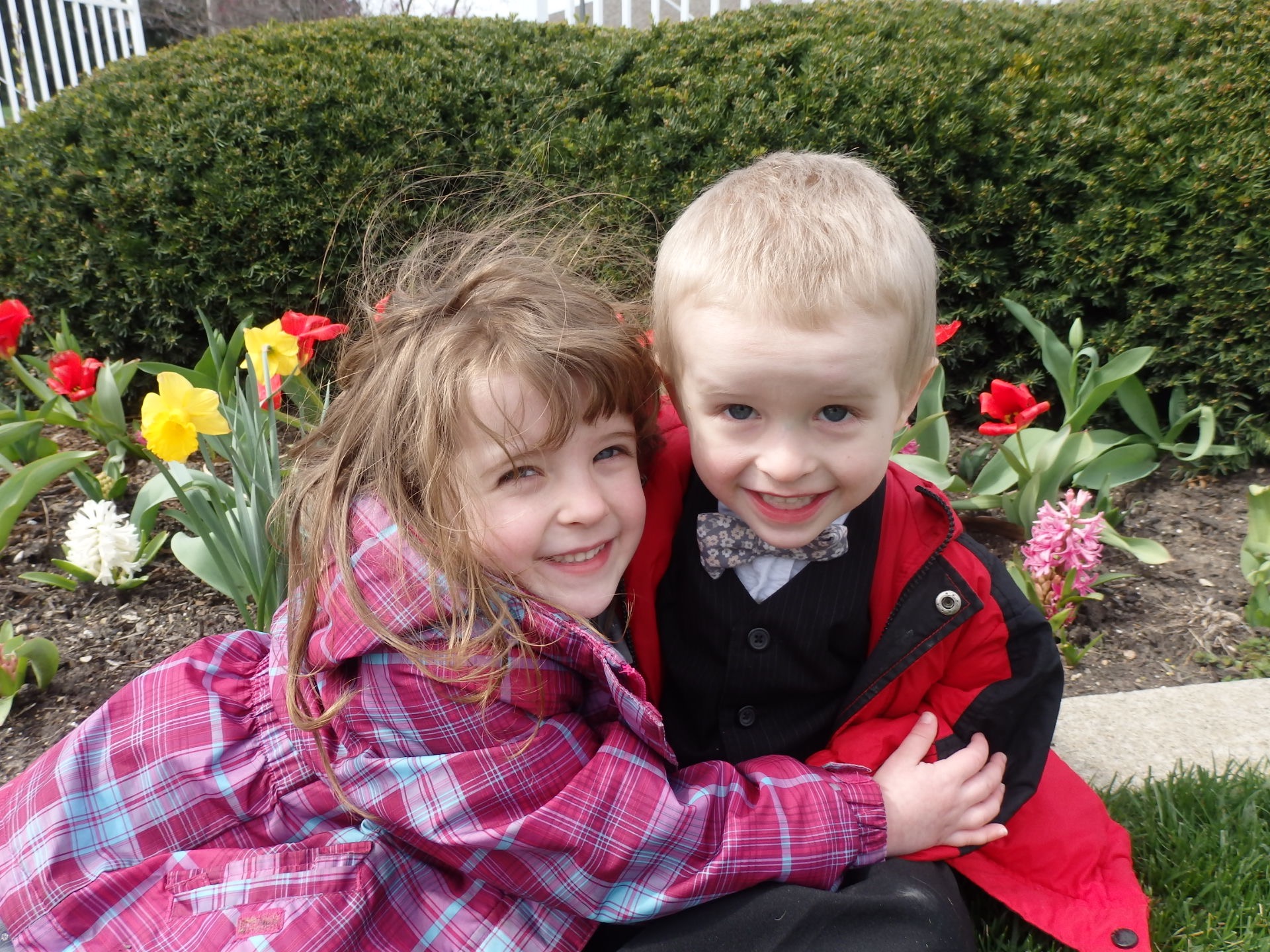 Heidi hugging Peter near flowers