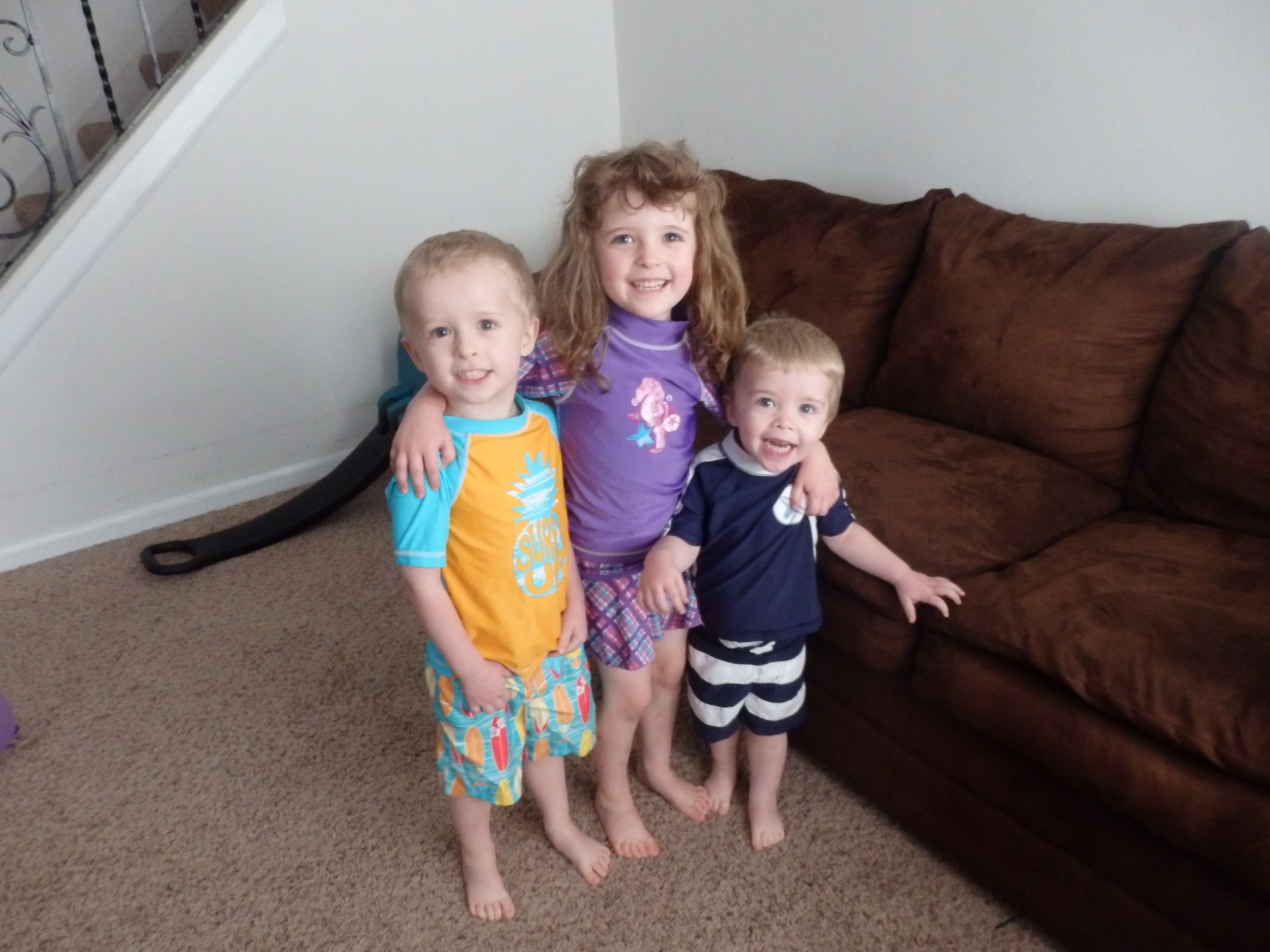 three kids in swimsuits