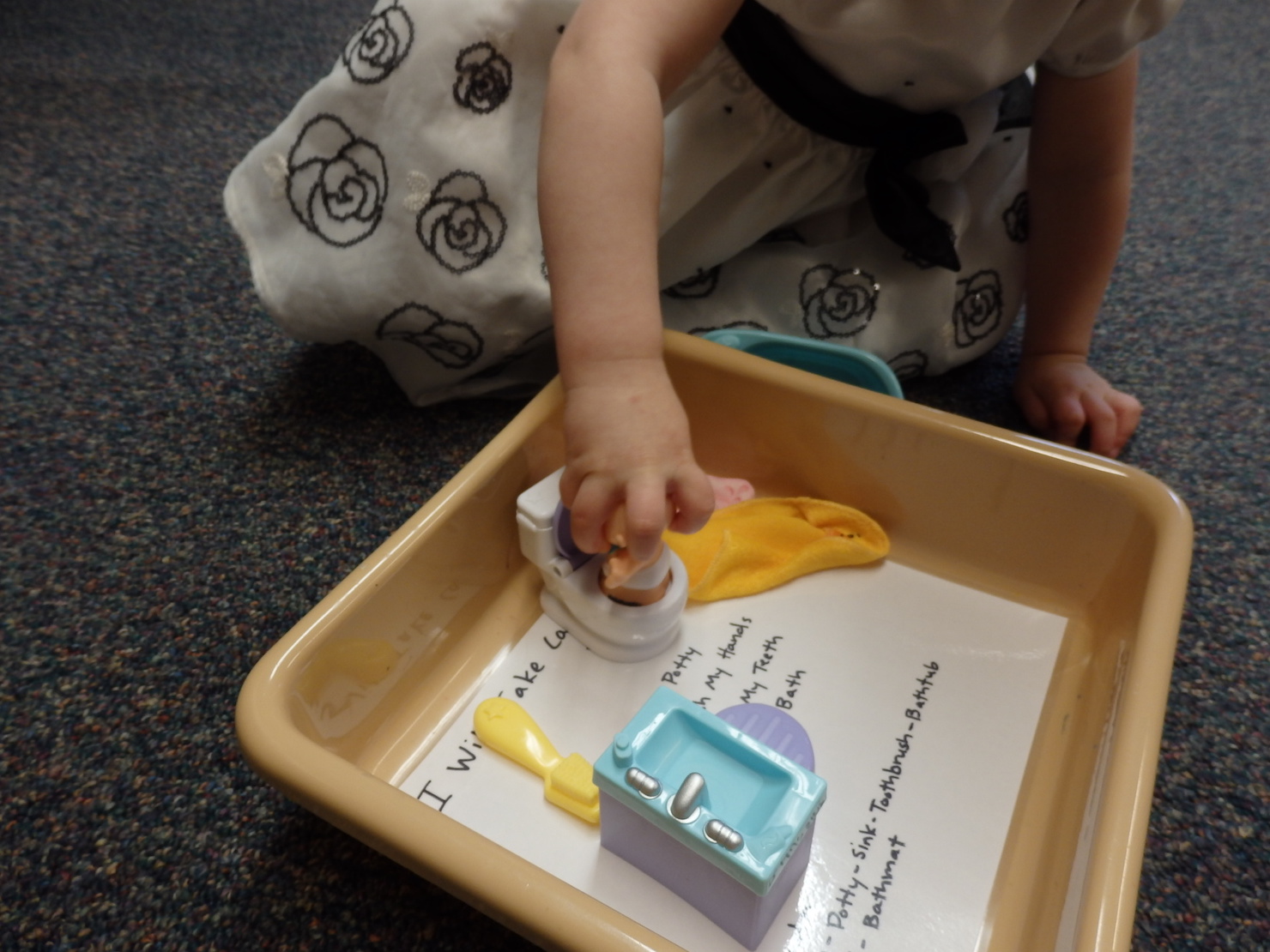 bethany playing with potty in the box it's carried in