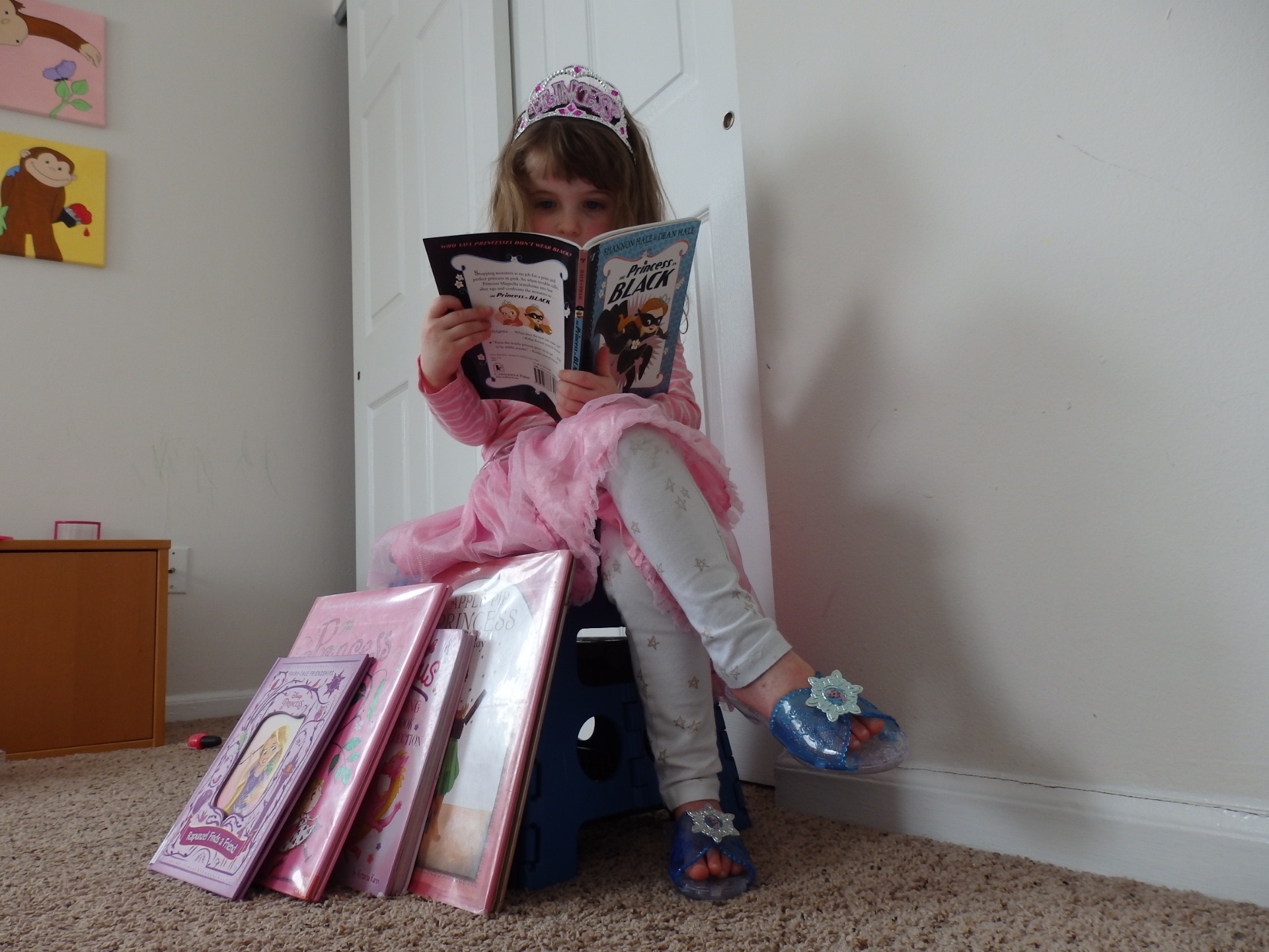 Heidi reading Princess in Black with grown-up crossed legs