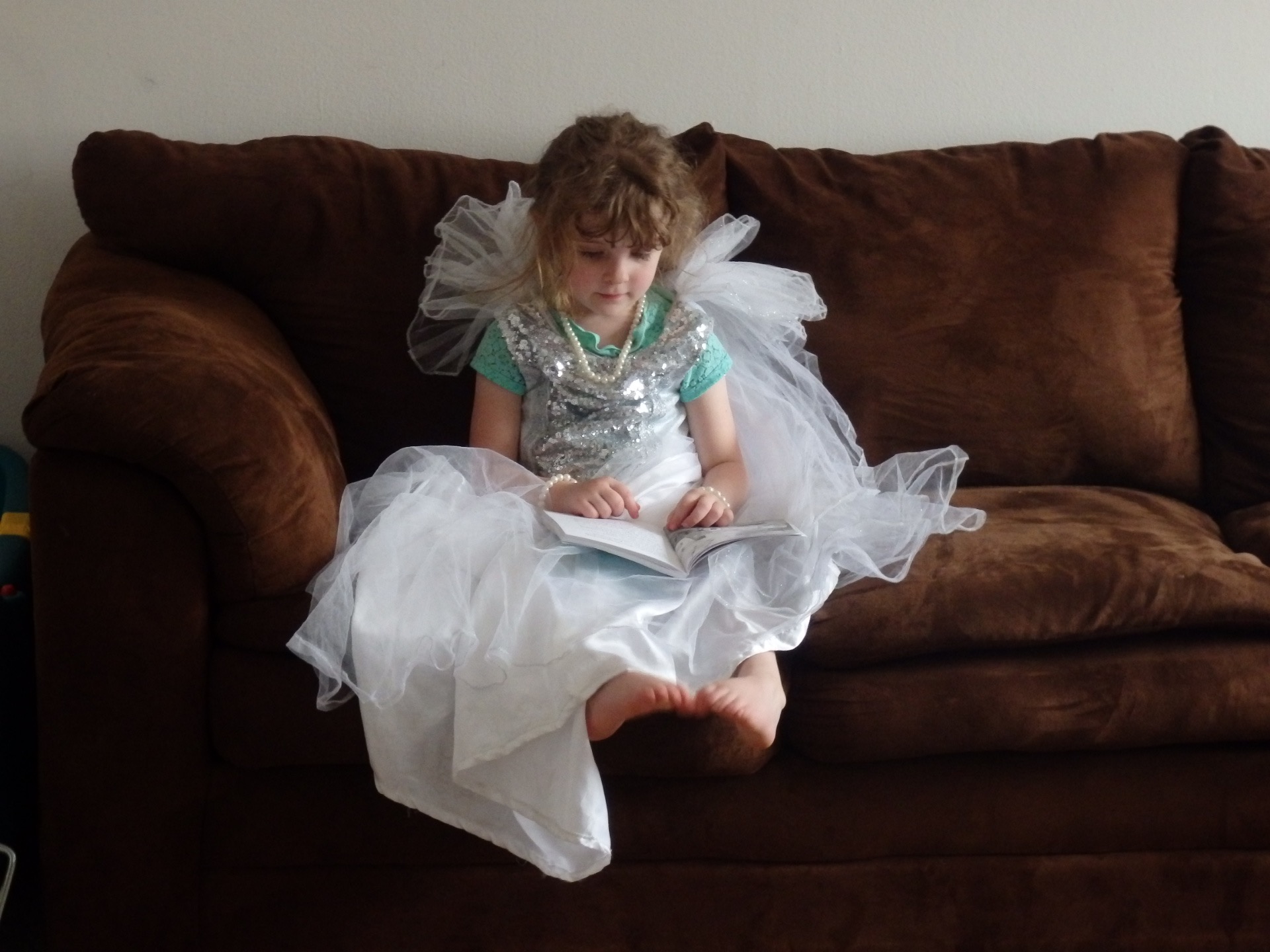 heidi reading a fairy book in a white fairy dress