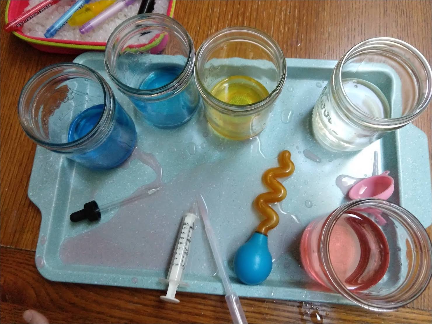 tray with jars of food colored water