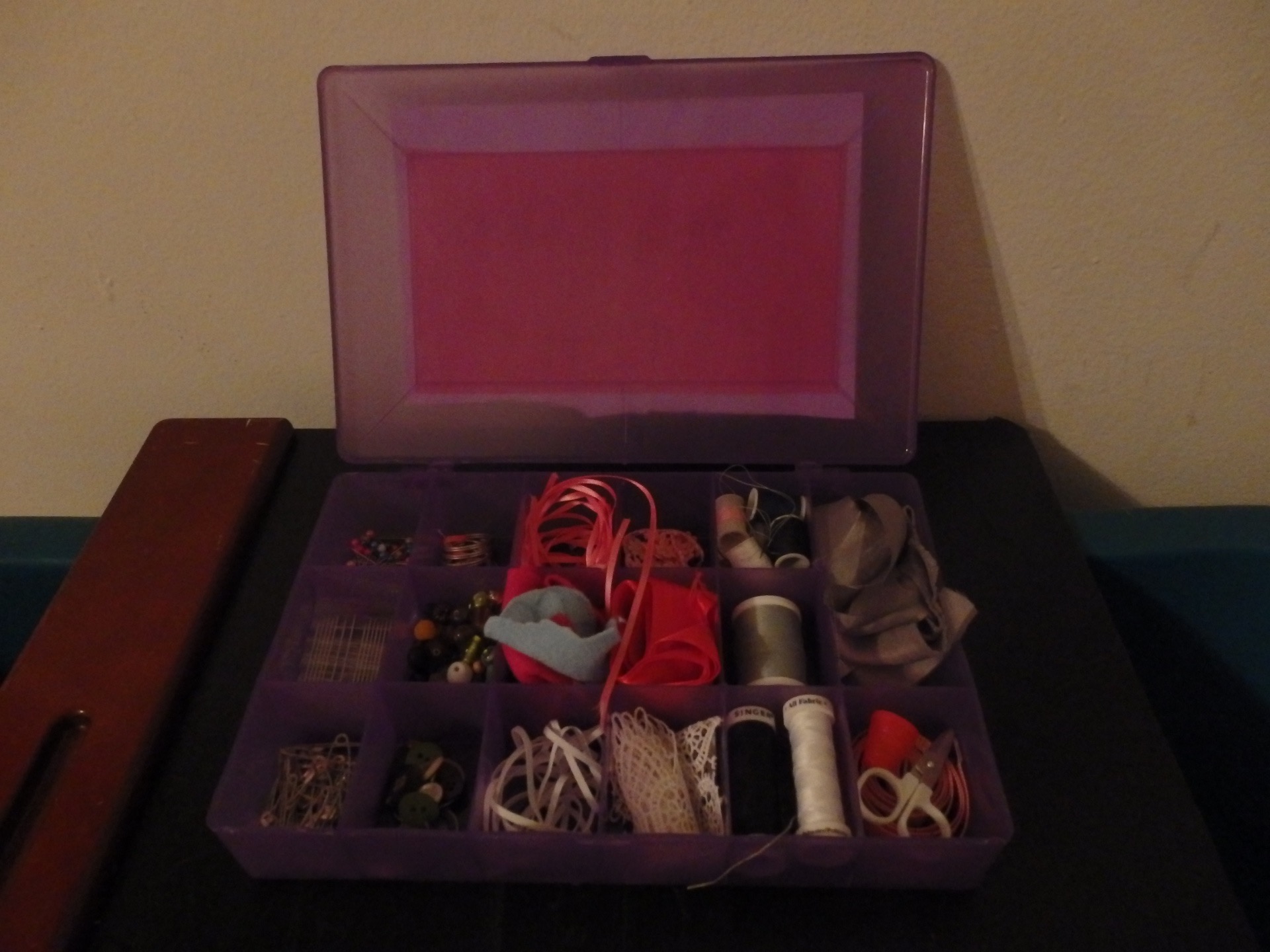 bead organizer full of thread, needles, buttons, felt, beads, thimbles