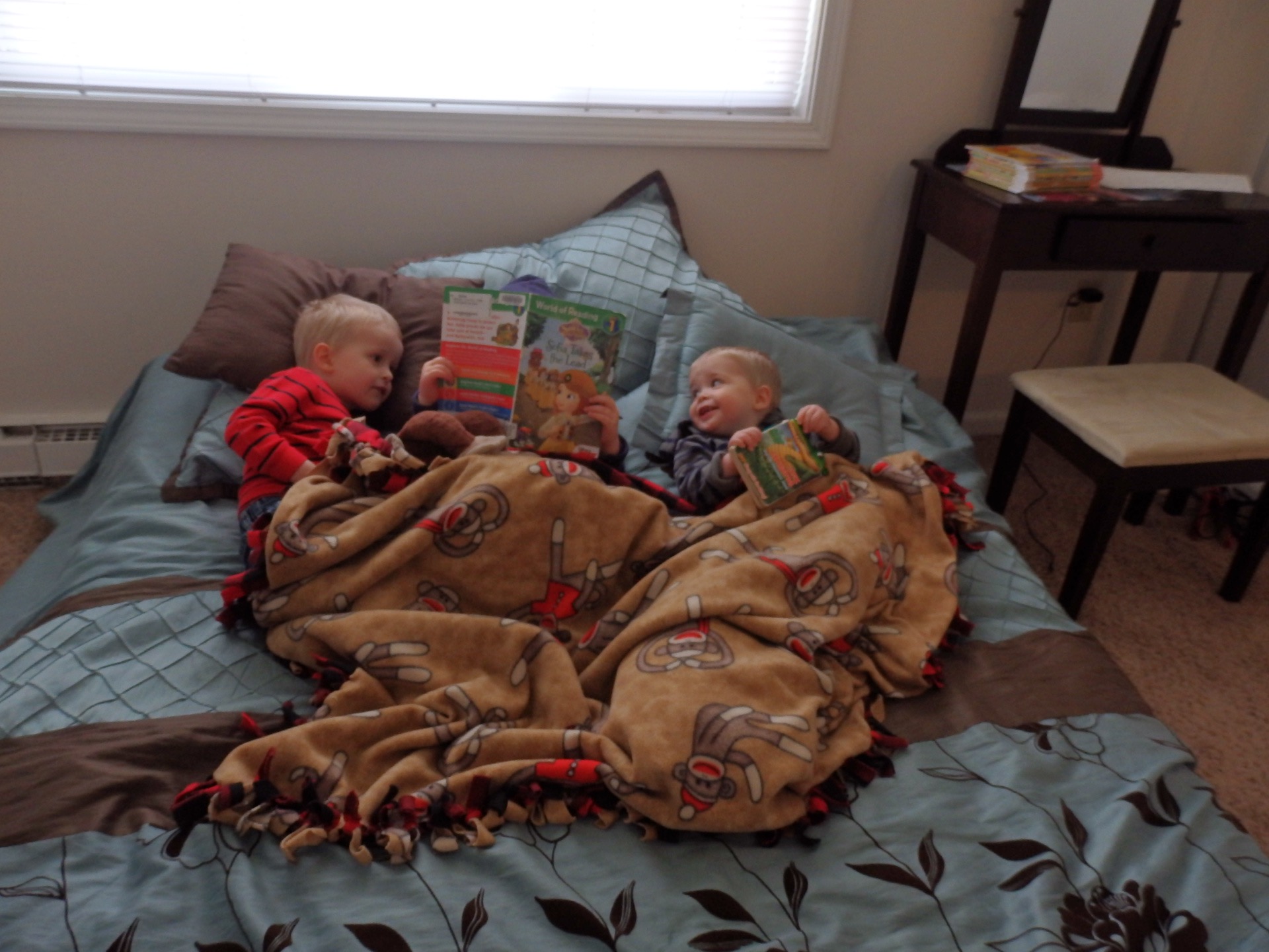 kids snuggling and reading together