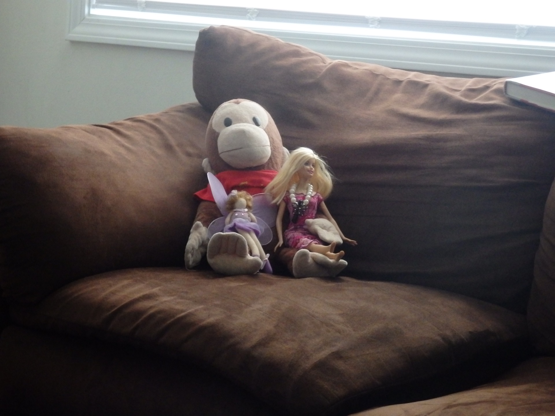 monkey, barbie, and fairy on couch watching